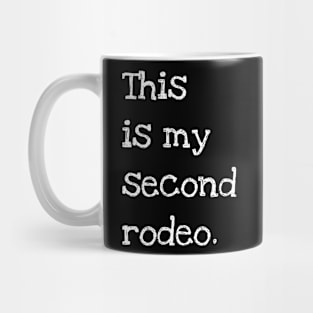 "This is my second rodeo." in plain white letters - cos you're not the noob, but barely Mug